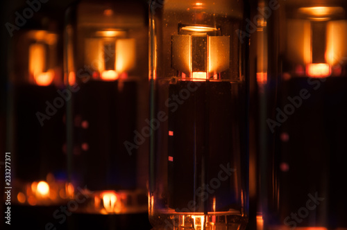 glowing electronic tube in guitar amplifier photo