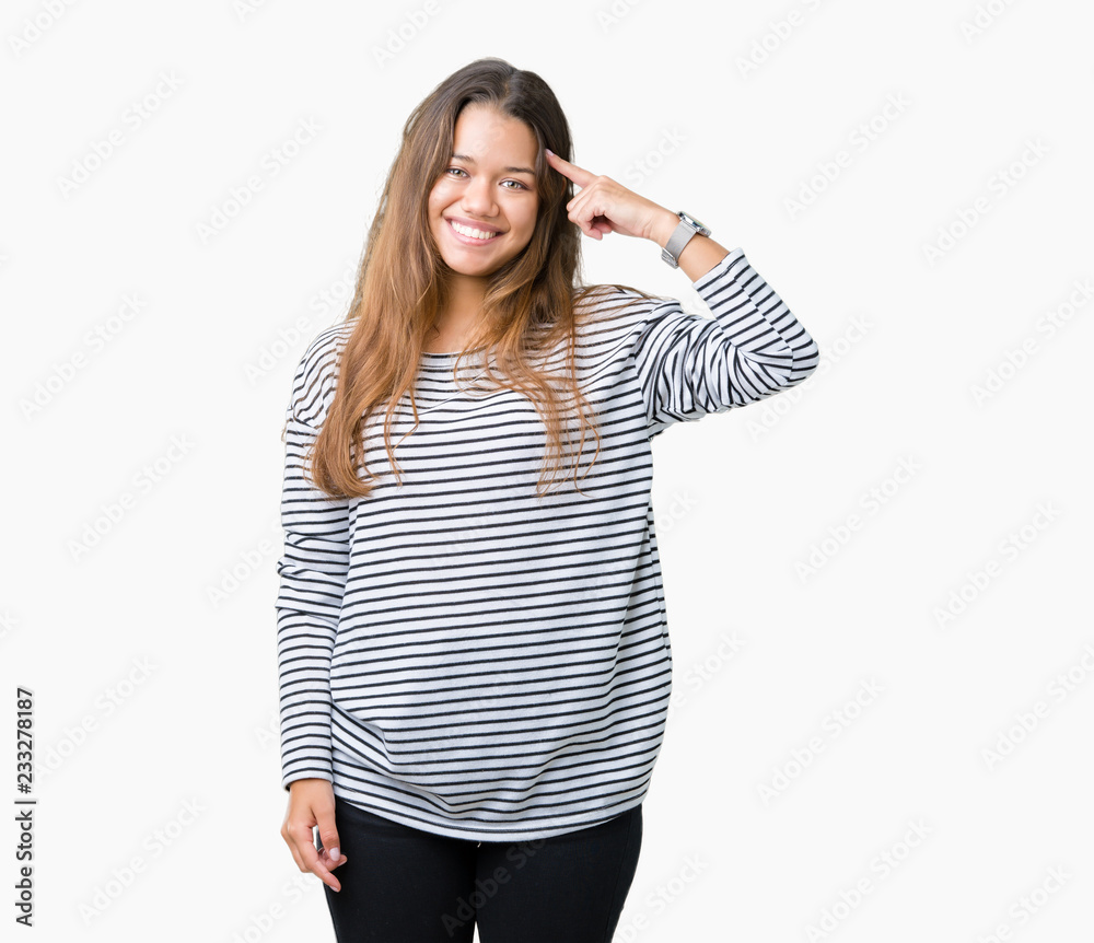 Young beautiful brunette woman wearing stripes sweater over isolated background Smiling pointing to head with one finger, great idea or thought, good memory Young beautiful brunette woman wearing stripes sweater over isolated background Smiling pointing to head with one finger, great idea or thought, good memory