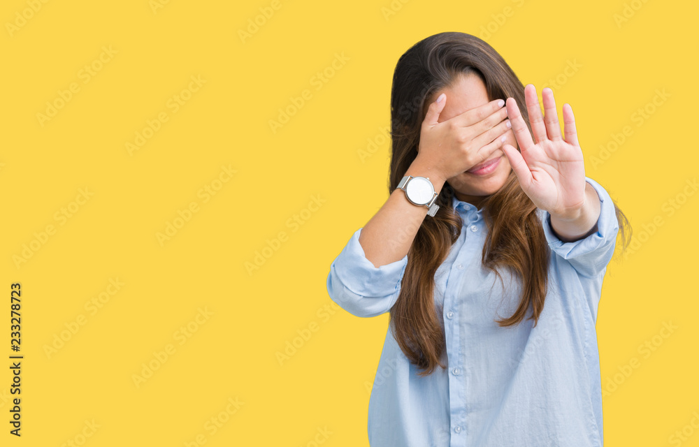 Young beautiful brunette business woman over isolated background covering eyes with hands and doing stop gesture with sad and fear expression. Embarrassed and negative concept. Young beautiful brunette business woman over isolated background covering eyes with hands and doing stop gesture with sad and fear expression. Embarrassed and negative concept.