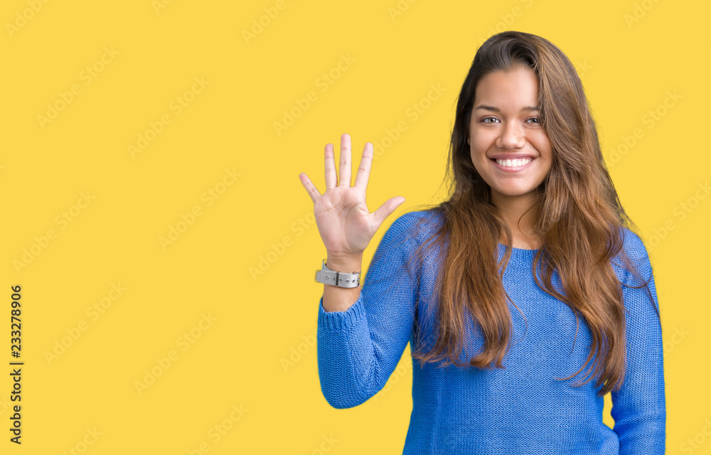 Young beautiful brunette woman wearing blue sweater over isolated background showing and pointing up with fingers number five while smiling confident and happy. Young beautiful brunette woman wearing blue sweater over isolated background showing and pointing up with fingers number five while smiling confident and happy.