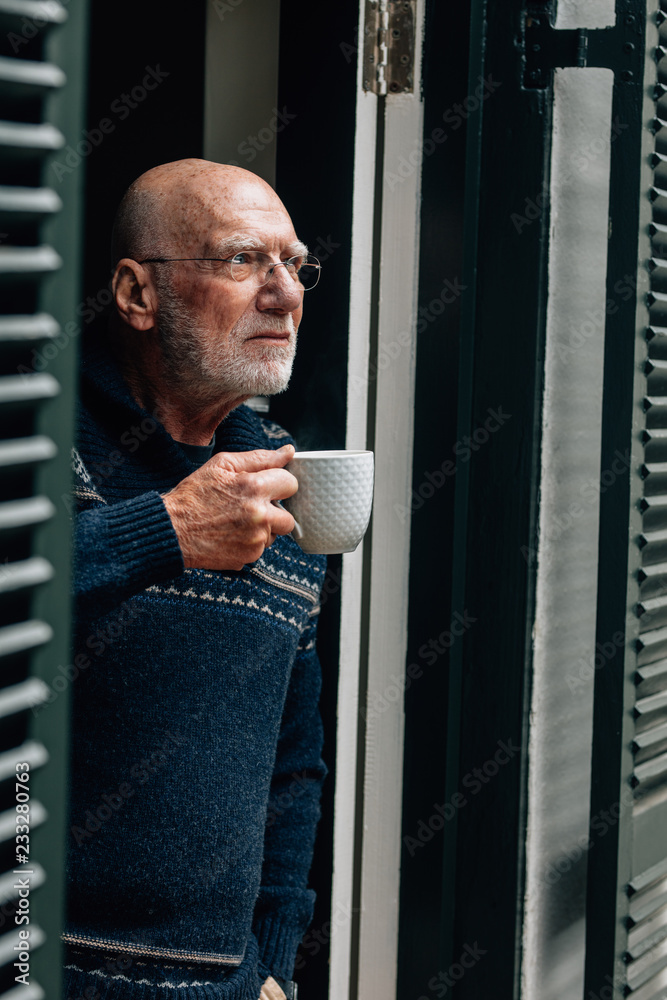 Portrait of a old man holding a coffee cup Photos | Adobe Stock