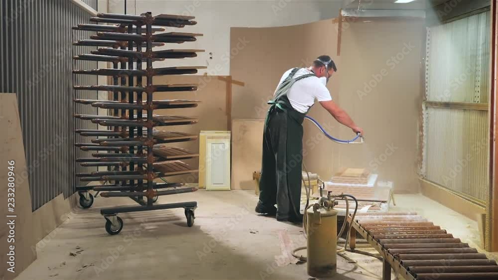 specialist using a spray gun sprays adhesive composition Stock ビデオ