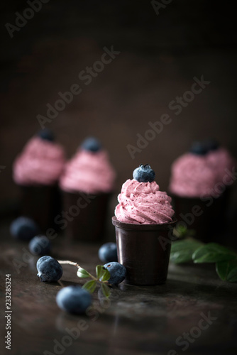 Vegan blueberry cream in chocolate cups photo