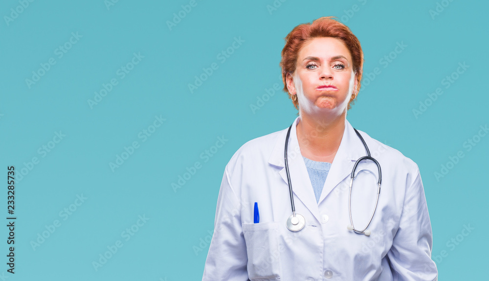 Senior caucasian doctor woman wearing medical uniform over isolated background puffing cheeks with funny face. Mouth inflated with air, crazy expression.
