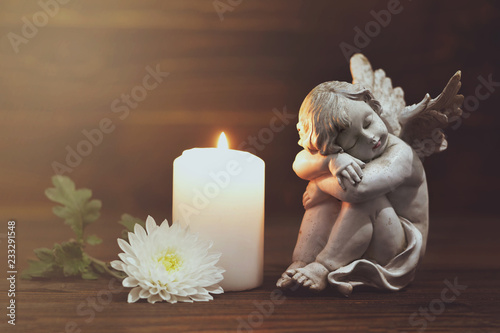 Angel, white flower and burning candle