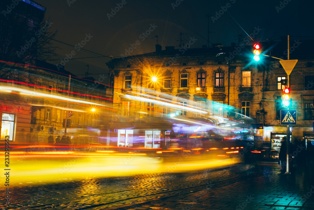Lviv  night car trails on the vintage building background, ukraine