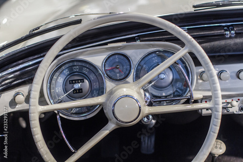 Old car dashboard and instrument claster on beige interior