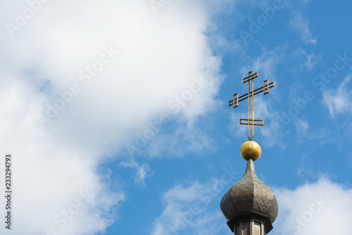 Church cross close up against a blue sky. The concept of the Orthodox religion and Christianity