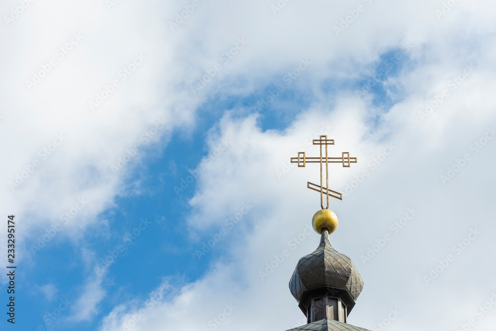 Church cross close up against a blue sky. The concept of the Orthodox religion and Christianity
