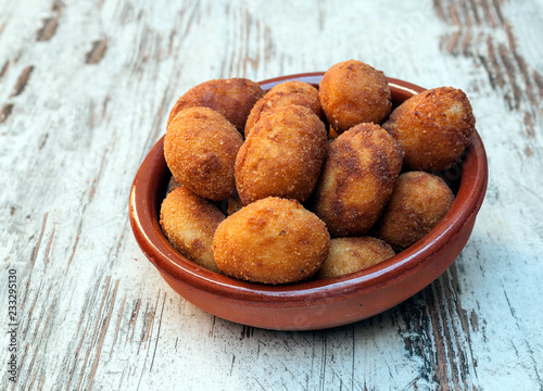 Croquettes surrounded by rustic background