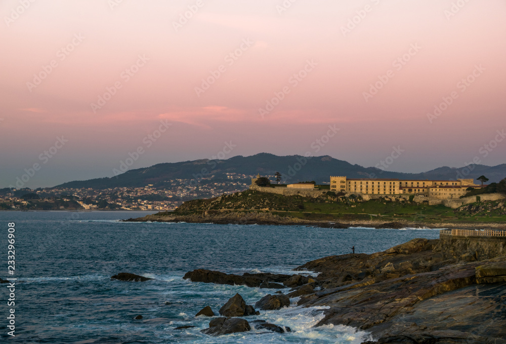 Sunset views in baiona with famous castle hotel and Nigran in the background