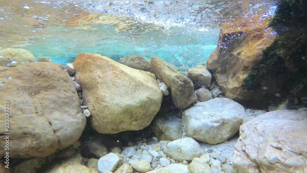 Slow motion underwater: Amazing mountain river flow with bubbles and turquoise water. UHD Slow motion underwater: Amazing mountain river flow with bubbles and turquoise water. UHD