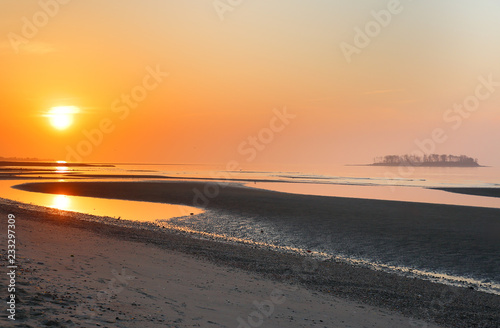 Overview of beautiful Silver Sands Beach at sunrise at low tide at Silver Sands State Park   Milford Connecticut  USA. Photo shows Charles Island in the background.