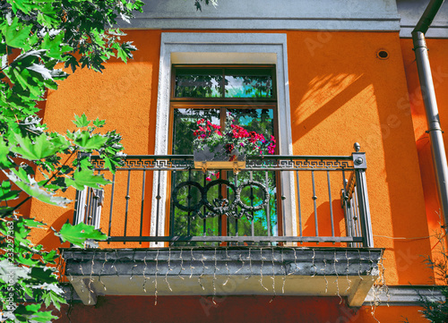 ST. PETERSBURG, RUSSIA - 8 August 2018: Beautiful sunny balcony with flowers on the building of Lyceum fund of A.S. Pushkin in Tsarskoye Selo photo