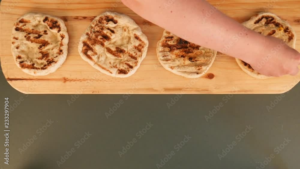 Overhead close up, person places corn kernels pizza