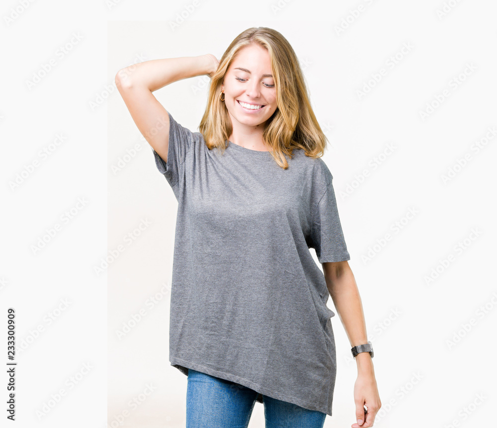 Fototapeta premium Beautiful young woman wearing oversize casual t-shirt over isolated background Dancing happy and cheerful, smiling moving casual and confident listening to music