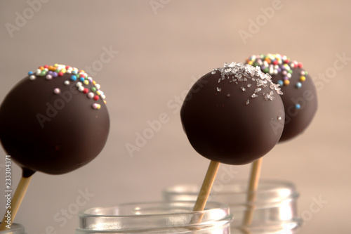 Three delicious chocolate cake pops in a jar.