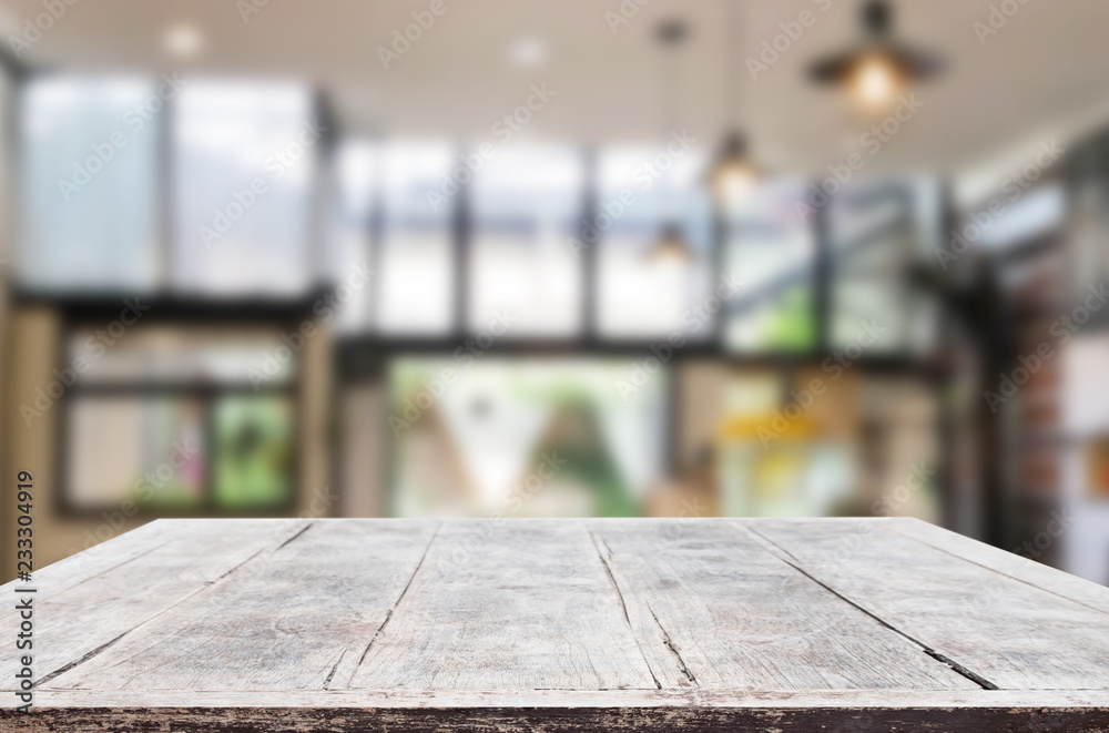 Wooden board empty Table Top And Blur Interior over blur in coffee shop Background, Mock up for display of product Wooden board empty Table Top And Blur Interior over blur in coffee shop Background, Mock up for display of product