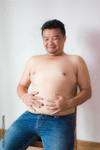 Asian fatman with big belly in worry action photo