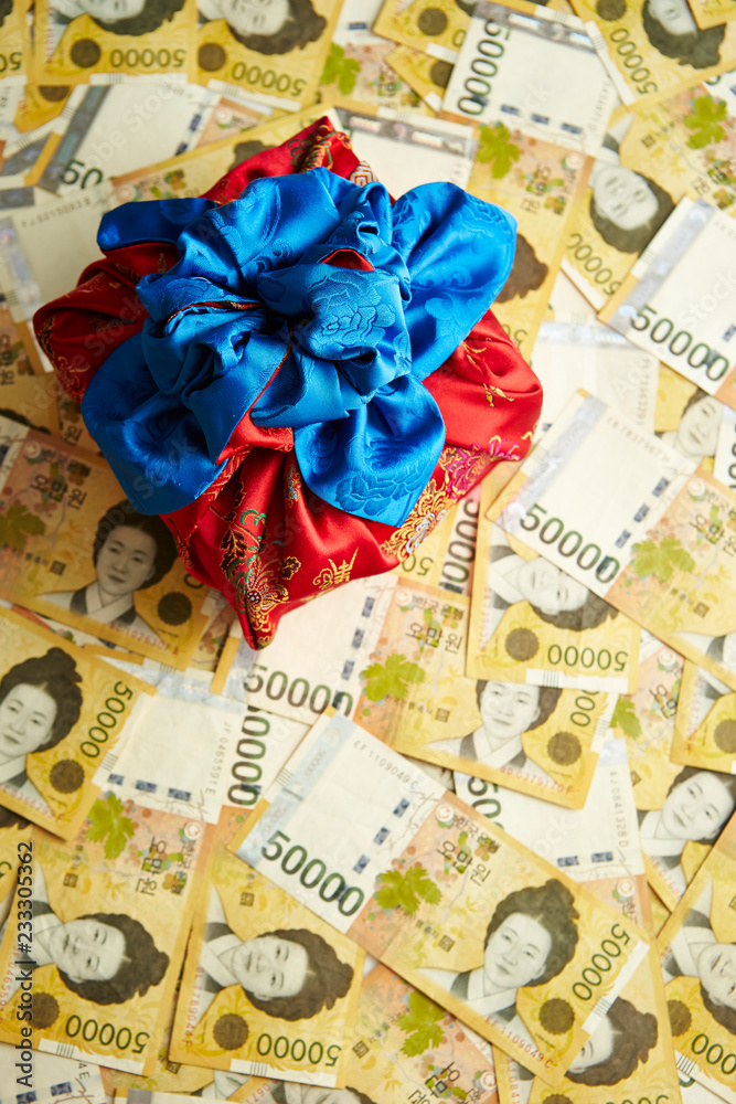Traditional Korean wrapping cloth with Korean won banknotes background Traditional Korean wrapping cloth with Korean won banknotes background