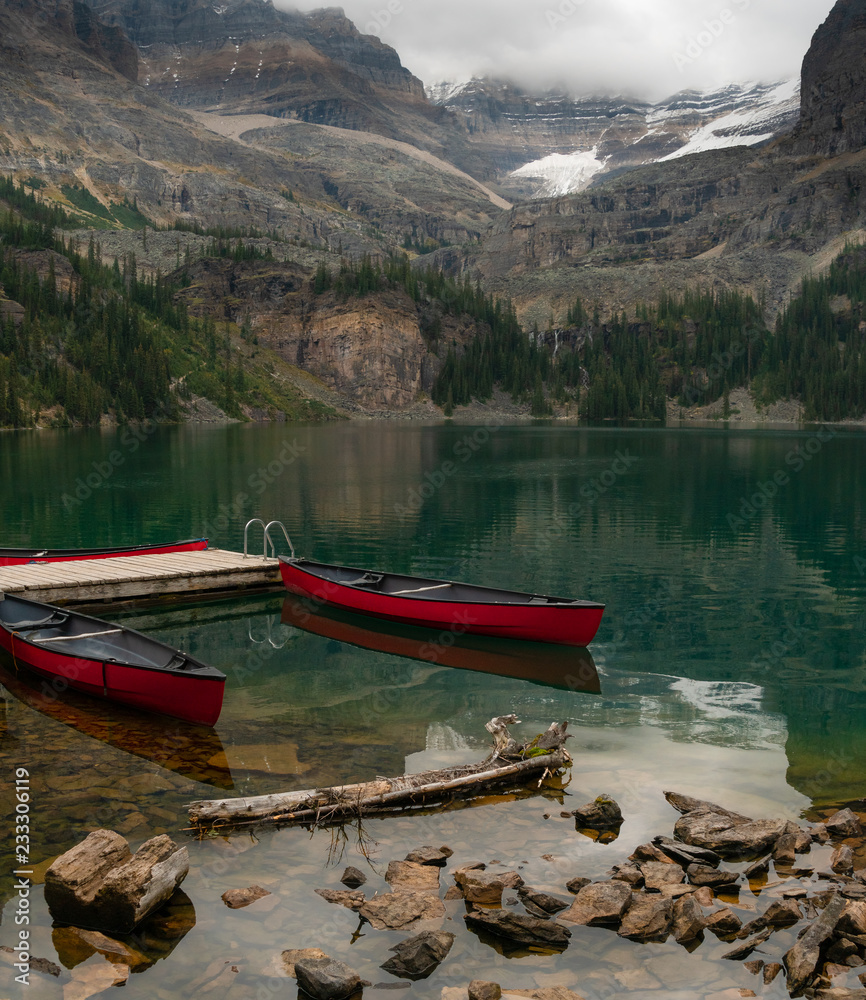 Two canoes in an alpine lake awaiting use high in the Canadian Rockies