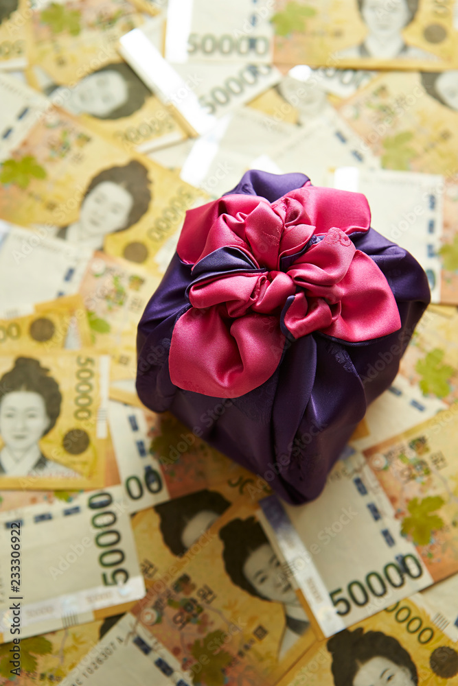 Traditional Korean wrapping cloth with Korean won banknotes background Traditional Korean wrapping cloth with Korean won banknotes background