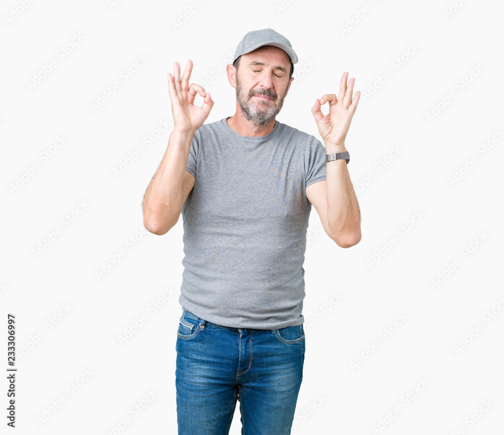 Naklejka premium Handsome middle age hoary senior man wearing sport cap over isolated background relax and smiling with eyes closed doing meditation gesture with fingers. Yoga concept.