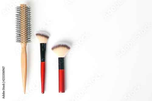 Red black makeup wooden hair brush comb beauty accessories on white background copy space border frame