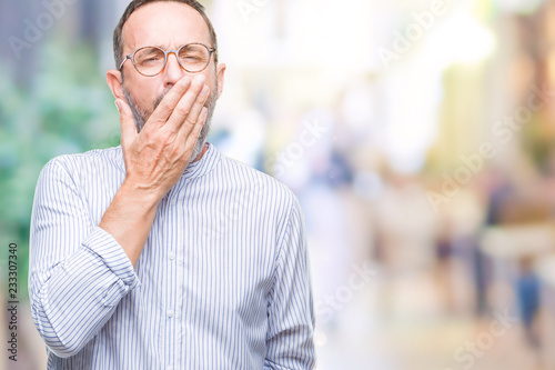 Middle age hoary senior man wearing glasses over isolated background bored yawning tired covering mouth with hand. Restless and sleepiness.