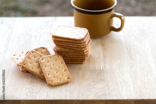 Milk cracker cookies Served with hot coffee on wooden desk ,Time break