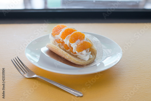 Orange topped on pancakes in coffee shop photo