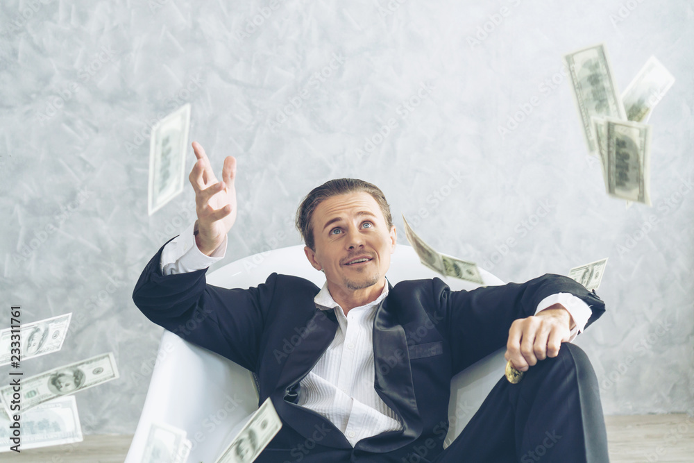 Happy business man very rich guy throw money dollar bills in air like