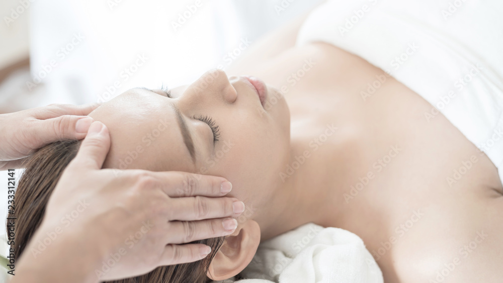 beautiful and healthy young woman relaxing with face massage at beauty spa salon beautiful and healthy young woman relaxing with face massage at beauty spa salon