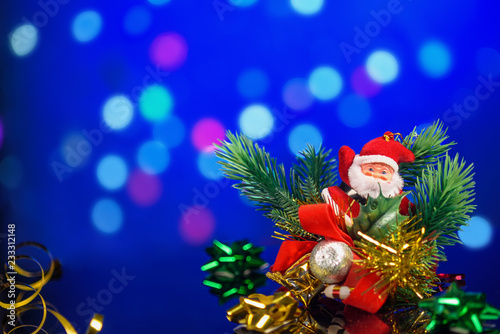toys, gifts, Christmas decorations on table with reflection on bokeh background with blurred background