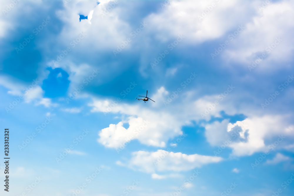 Bright blue sky with clouds and the helicopter Bright blue sky with clouds and the helicopter