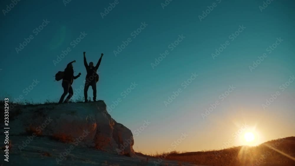 Teamwork victory tourists. Two Tourists Jumping Happy Happiness goal achievement Nature Landscape. teamwork. two tourists hikers men and dog with backpacks walking at sunset go hiking trip. slow Teamwork victory tourists. Two Tourists Jumping Happy Happiness goal achievement Nature Landscape. teamwork. two tourists hikers men and dog with backpacks walking at sunset go hiking trip. slow