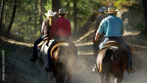 Horses galloping in Roundup on Dude Ranch with Cowboy Riders  photo