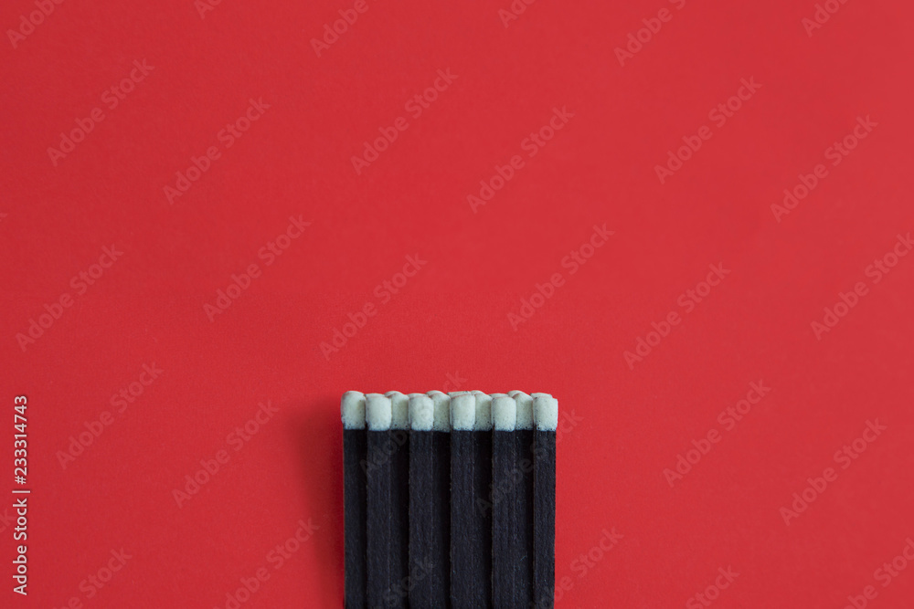 Matchstick on red background.Red paper space.