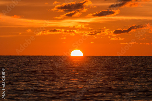 Horizon view angle of Sunset sun down moment at beach © alenthien
