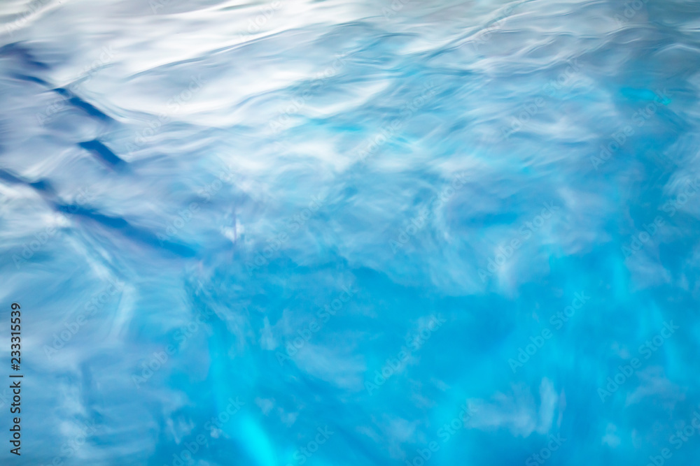 The smooth natural blue water background with bokeh abstract on the sea or ocean,vintage and soft colored blur. The smooth natural blue water background with bokeh abstract on the sea or ocean,vintage and soft colored blur.