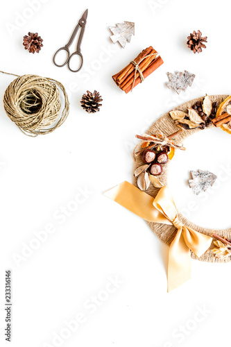 Process of making christmas wreath concept. Creative christmas wreath made of thread near matherials and instruments, sciccors on white background top view copy space