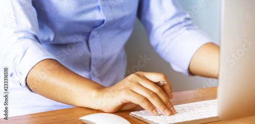 Lady working at home with computer,Her hand holding pen writing a blog and Creative idea of work 2019 goals, writing, drawing, making notes in document Business,investment,concept,Soft focus.