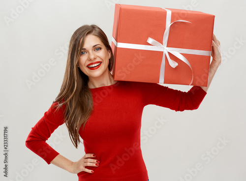 portrait of happy woman holding red ift box on shoulder. photo