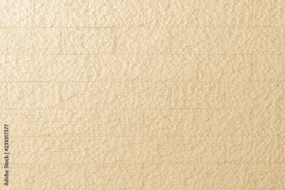 Modern rough marble rock tiled detail wall texture pattern background in pastel yellow cream color Modern rough marble rock tiled detail wall texture pattern background in pastel yellow cream color