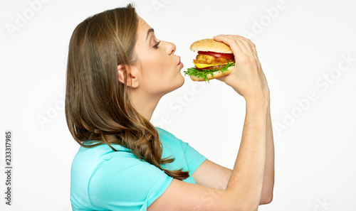 Young woman biting burger isolated portrait