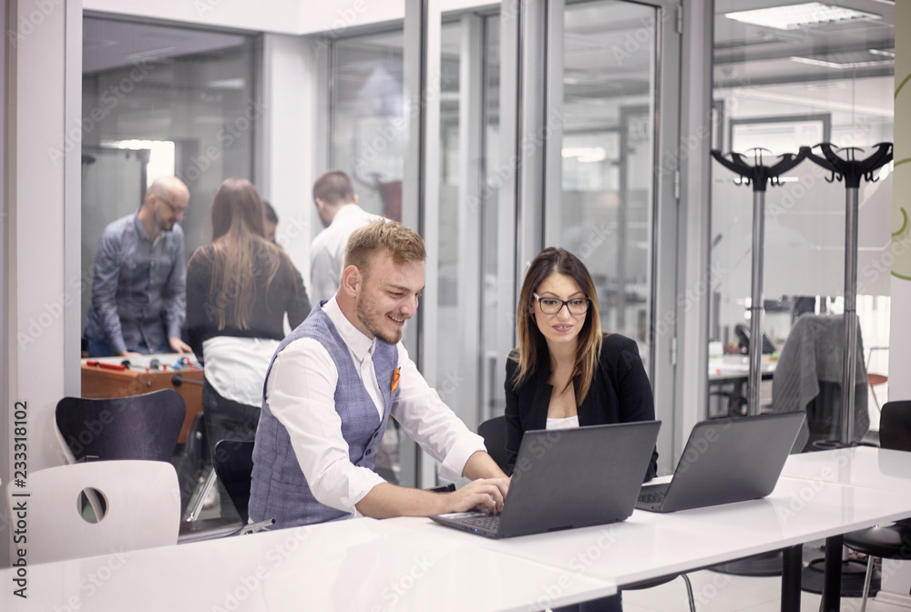 group of people, working on laptop, some relaxing having fun playing table football, indoors modern office building. group of people, working on laptop, some relaxing having fun playing table football, indoors modern office building.
