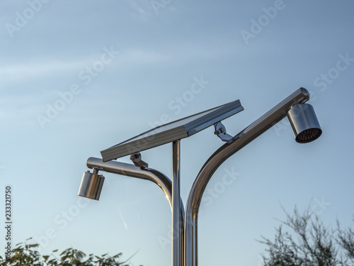 photovoltaic panel producing power for shower standing on the beach closeup
