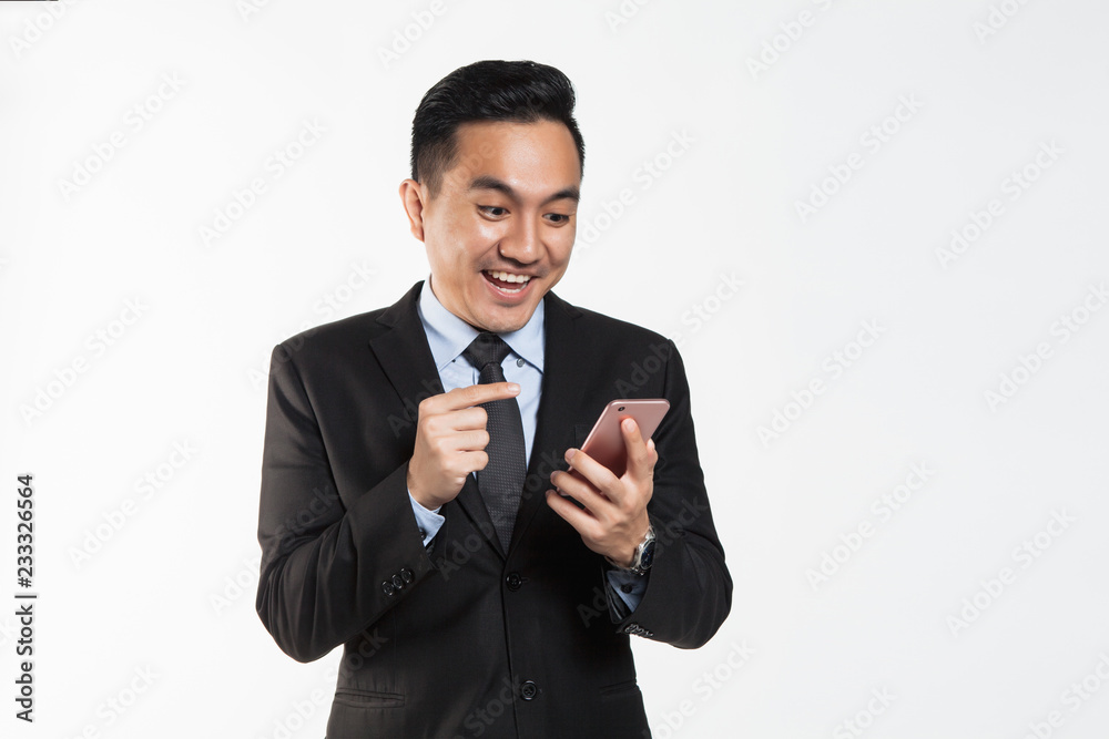 Man with winning and success expression looking at his phone Man with winning and success expression looking at his phone