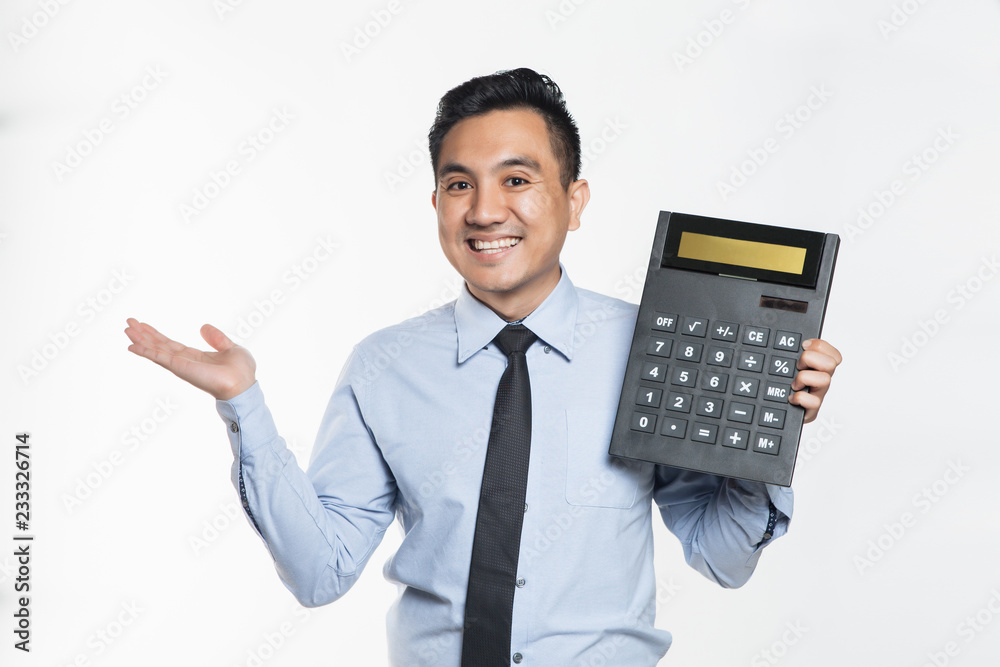 Man in office wear holding a big calculator Man in office wear holding a big calculator