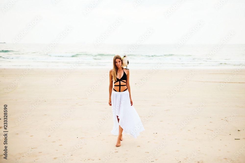 A beautiful young blonde enjoying life on the beach, with a wild albatross on her shoulder. A beautiful young blonde enjoying life on the beach, with a wild albatross on her shoulder.